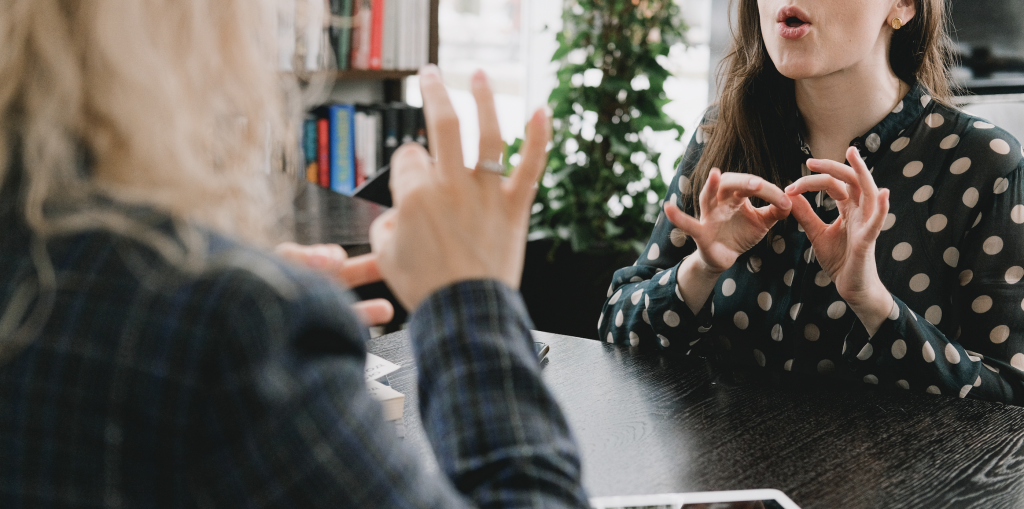 Two women have a conversation using ASL American Sign Language after practicing with Sign Language Blitz