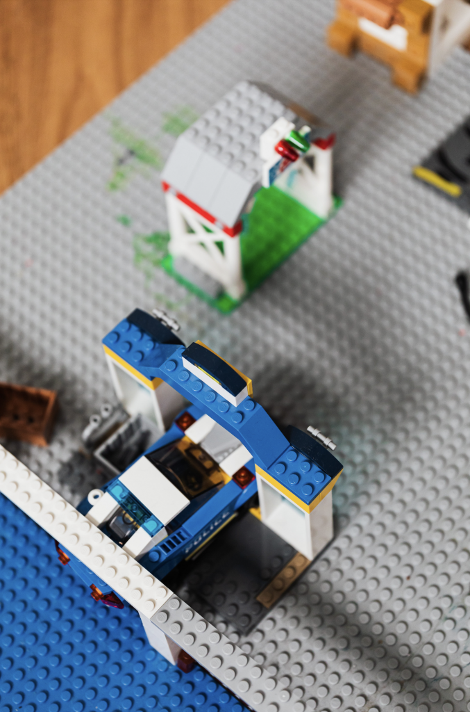 A lego police station sits in the left hand corner of the screen. Next to it is another lego building. Lego Diversity with Sign Language Blitz.
