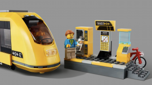 The hearing aid lego figure stands next to a subway and a subway station. Image by LEGO.