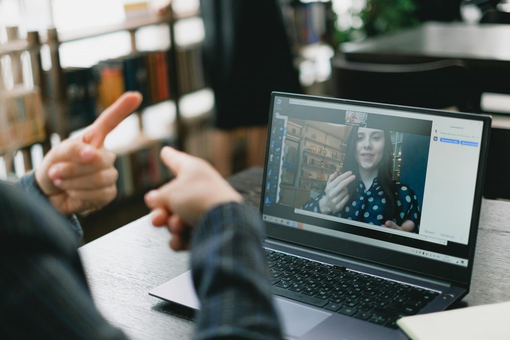 A person is learning American Sign Language through video chat.