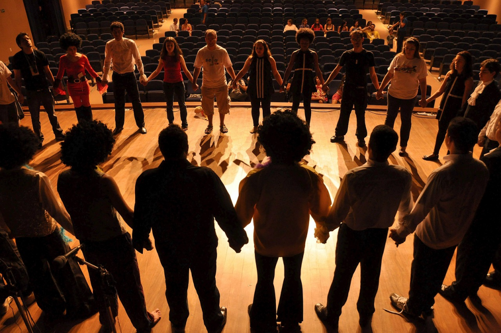 Deaf West Theatre's performance of All American Idiot debuted on the Mark Taper Forum in Los Angeles. Actors gather around in a circle and hold hands on stage during warm ups before the show.